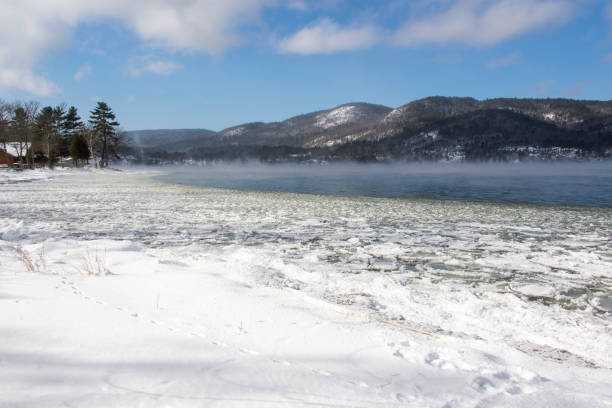 istock Winter scene with a lake and ice steam 1367870107