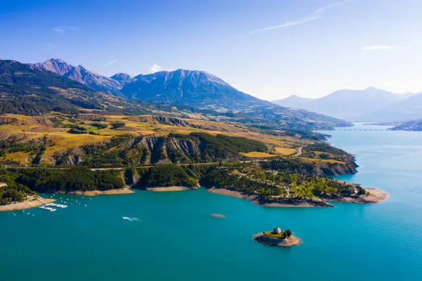 Picturesque view over artificial lake of Lac de Serre-Poncon in departments of Hautes-Alpes and Alpes-de-Haute-Provence, France
