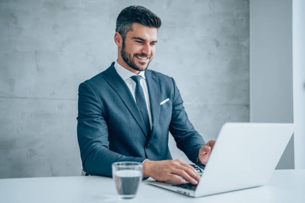 istock Successful businessman in modern office working on laptop. 1367872498