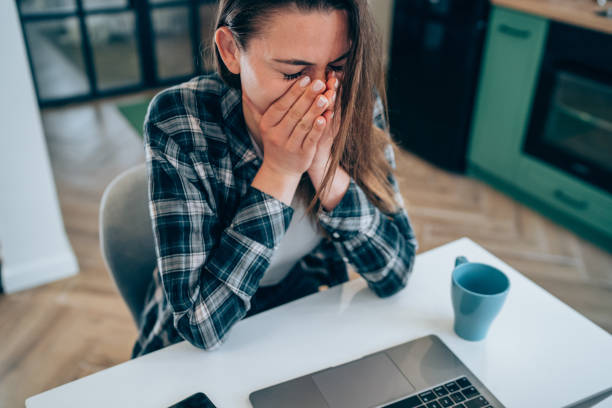 istock Stressed woman using laptop at home. 1367872502