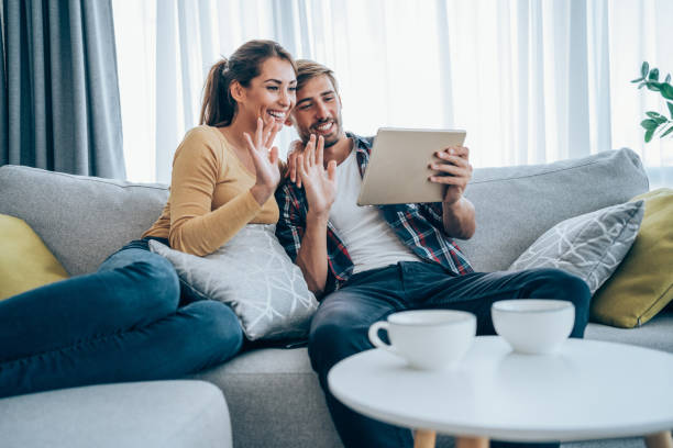 istock Couple making video call on digital tablet at home. 1367873983