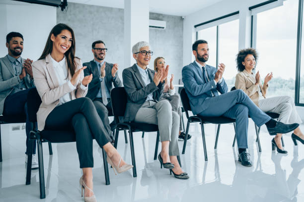 istock Businesspeople applauding during a seminar in conference hall. 1367874006