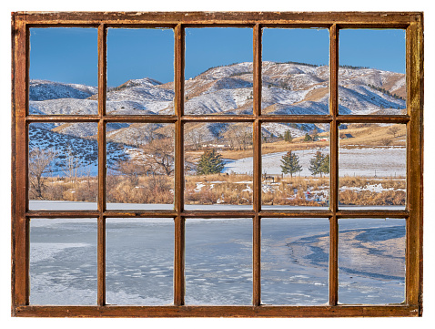 Early winter morning at Colorado foothills of Rocky Mountains, vintage sash window view