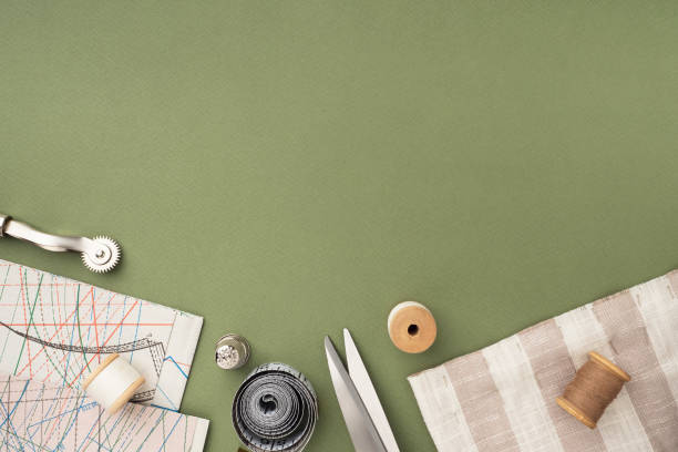 istock Pattern, fabric and sewing accessories on a green paper background, flat, lay, top view, copy space. A tailor or seamstress desk. Sewing concept, background. Tailoring of designer clothes 1367874284