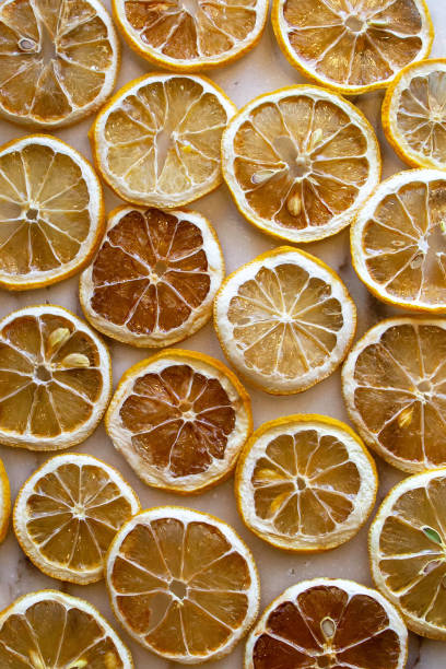 istock Dried oranges and lemons on a marble counter 1367875590