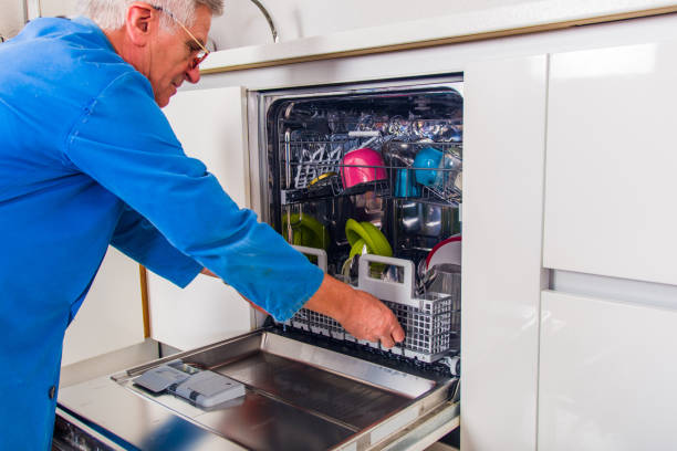 istock Senior plumber fixing the dishwasher machine in kitchen 1367875672