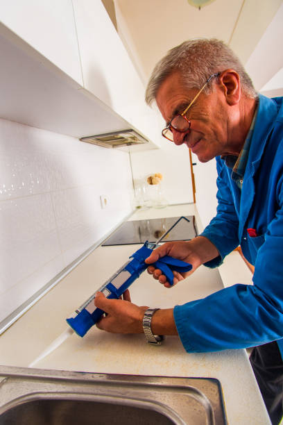 istock Senior man with his tool repairing kitchen basin 1367876166