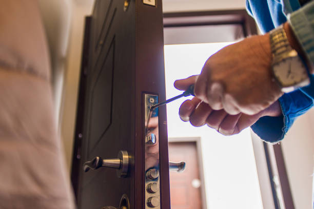 istock Workman standing near the door and fixing it 1367876177