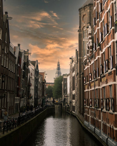 Buildings in Amsterdam canals at sunset time.