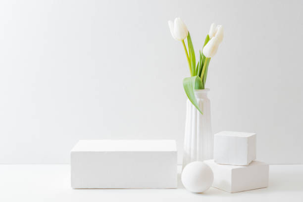 istock White podium for product display with white tulips in a vase on a light background 1367878372