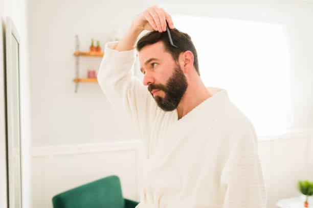 istock Hispanic man combing his shiny hair 1367878407