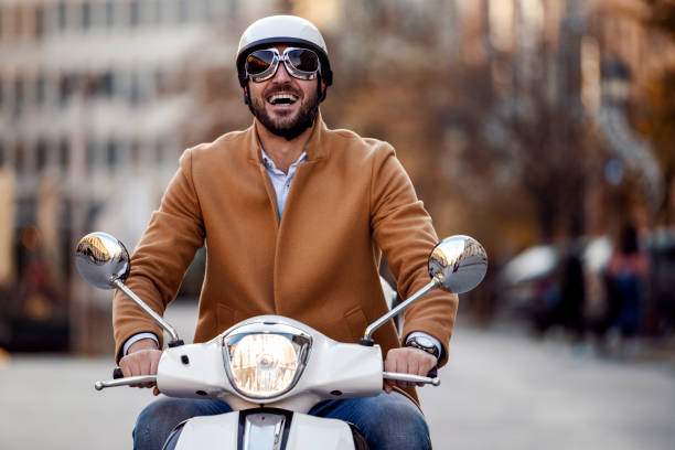Businessman with motorbike in town,enjoying after work.