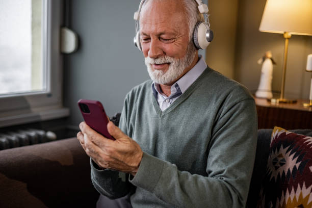 istock Portrait of senior man using smart phone at home 1367880432