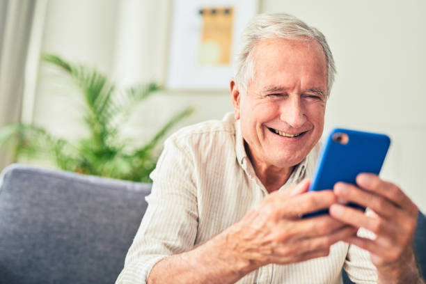 istock Shot of a senior man using his cellphone while sitting at home 1367880685