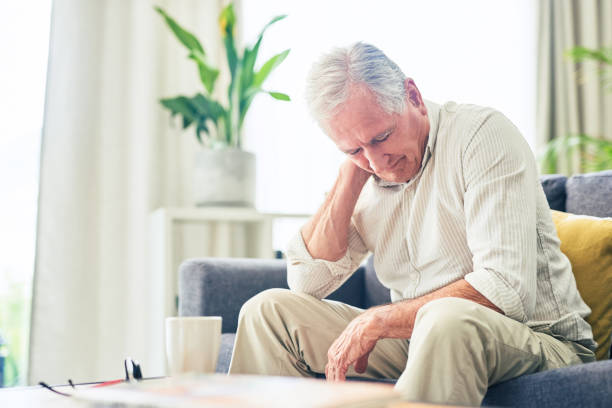 istock Shot of a senior man looking stressed while sitting at home 1367880696