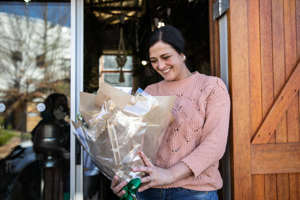 istock Happy Client Receiving a Flower Bouquet 1367883227