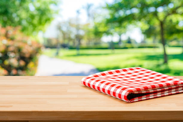 istock Folded blanket on picnic table and nature background 1367883480