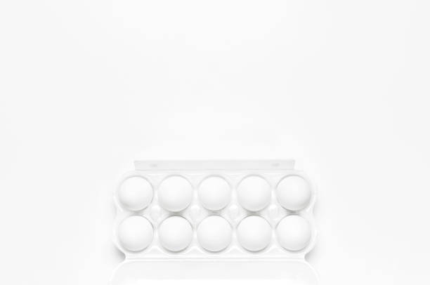 istock White chicken eggs in white packaging on light background top view flat lay copy space. Eggs in box, natural healthy food and organic farming concept. Creative food minimalistic background, Easter 1367884692
