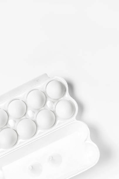 istock White chicken eggs in white packaging on light background top view flat lay copy space. Eggs in box, natural healthy food and organic farming concept. Creative food minimalistic background, Easter 1367884696