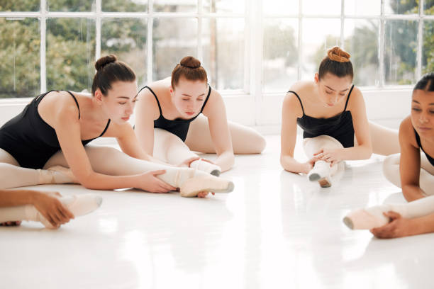 istock Shot of a group of ballerinas warming up before practicing their routine 1367885766