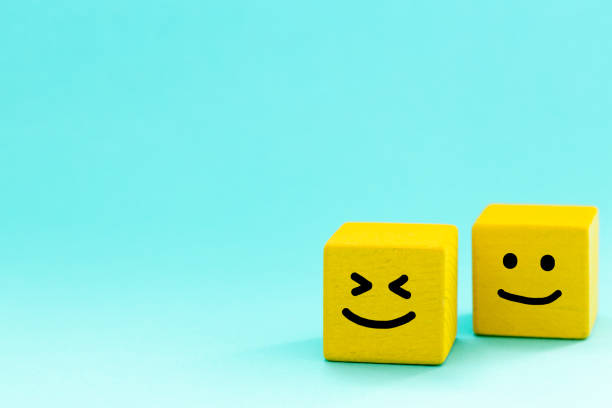 istock Positive mindset, Concept, Two yellow bricks with hand-painted smiles, pastel blue background, blank space, Joy of life and good mood 1367886304