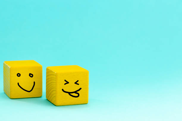 istock Positive mindset, Concept, Two yellow bricks with hand-painted smiles, pastel blue background, blank space, Joy of life and good mood 1367886306