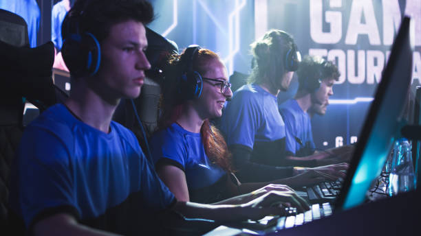 istock Focused men and women playing video game during competition 1367887030