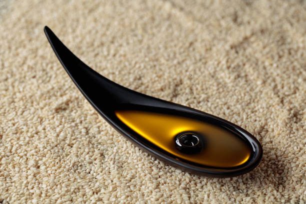 istock Sesame oil in small black bowl. 1367887335