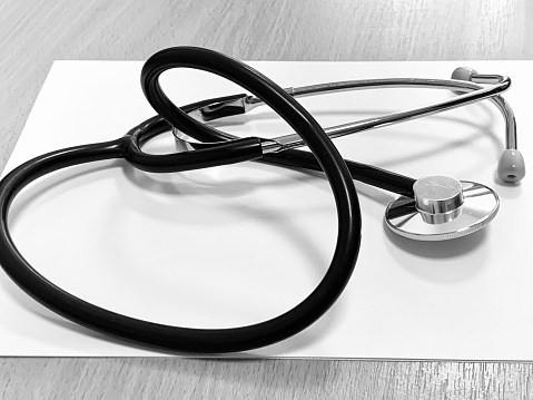 Stethoscope and a report isolated over white.