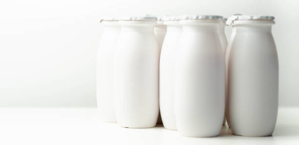 istock White plastic yogurt bottles on white background, typical packaging for dairy products 1367889004