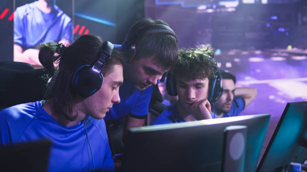 istock Gamers discussing strategy with coach before match 1367889019