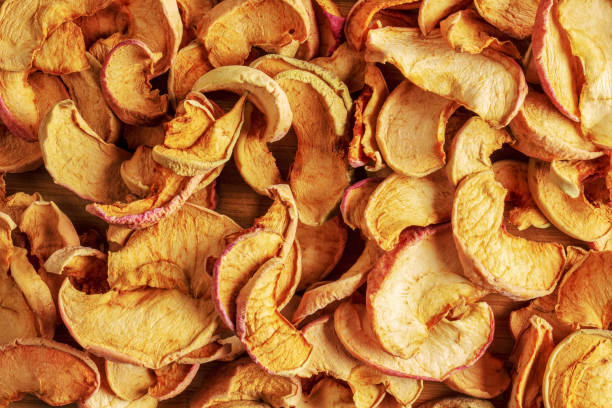 Background of dried apple slices. Chips from dried fruits. Healthy food. Top view stock photo