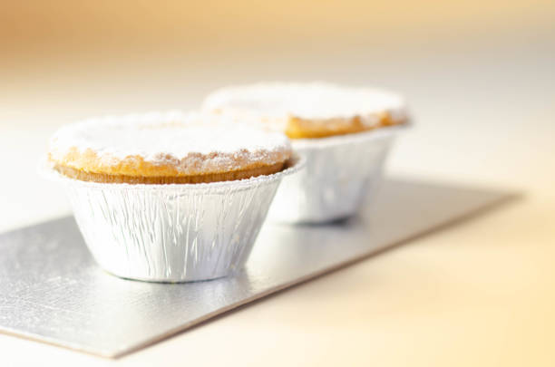 Baked apple pie in a pan on a wood surface
