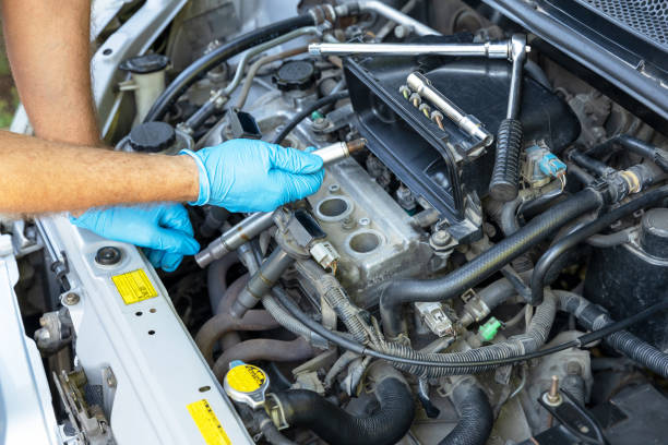 Misfiring car spark plug replacement. Repairing of vehicle. Mechanic changing car spark plugs engine failure stock pictures, royalty-free photos & images