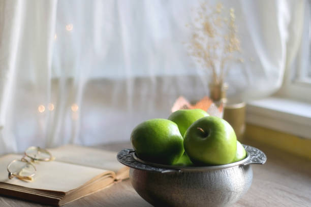istock Green Apples, Book and Candle 1367891600