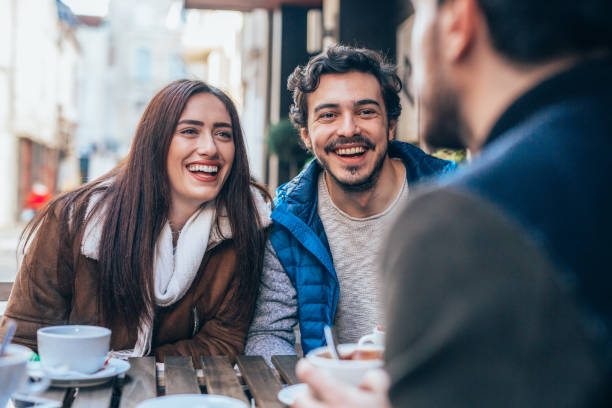 istock Friends talking and laughing in a cafe 1367891734