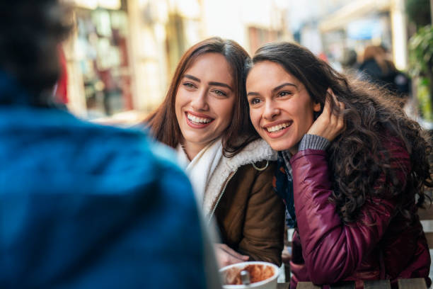 istock Friends talking and laughing in a cafe 1367891739