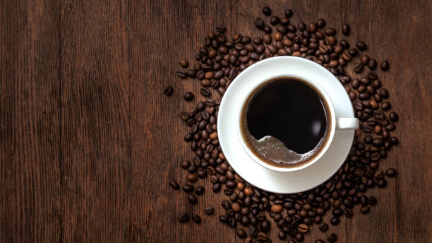 istock Black coffee and roasted coffee beans on a wooden table 1367891953