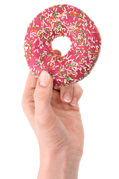 istock Donut close-up in hand on a white background. Round donut isolated on white background. 1367892066