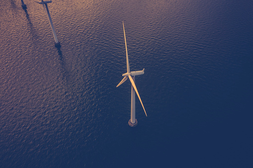 Aerial drone image of coastal wind turbines at a wind farm within the capital city, Copenhagen, Denmark.