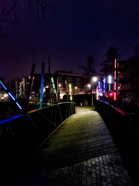 istock Colorfully illuminated bridge in the dark 1367892892