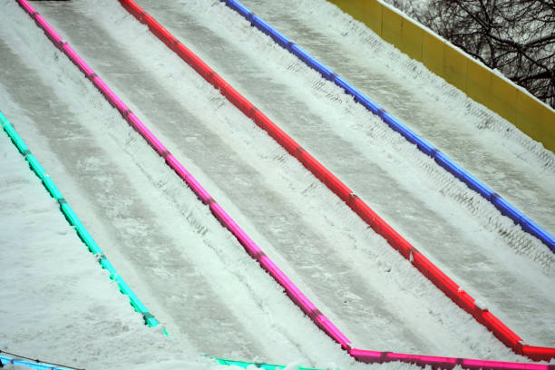 Ice slide for skiing with separation of tracks by luminous multi-colored railings.