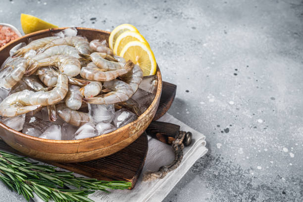 istock Uncooked Raw peeled tiger white shrimp prawn. Gray background. Top view. Copy space 1367895229