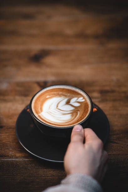 istock Hand holding cup of latte 1367895932