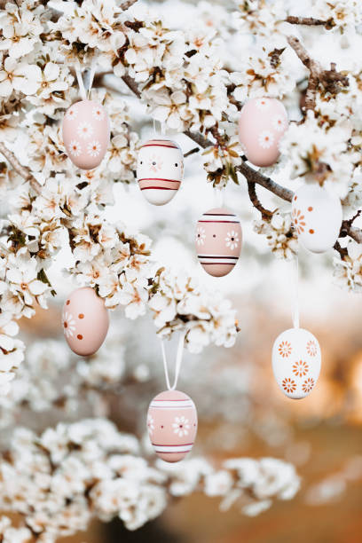 istock Eight boho easter eggs hanging in between almond blossoms on an almond tree 1367896001