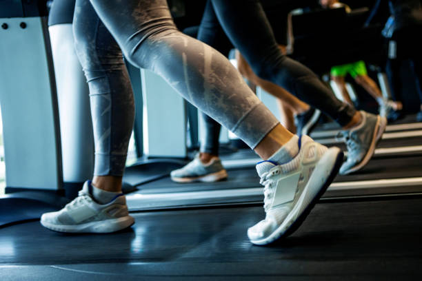 istock Unrecognizable people running on treadmill in gym 1367897227