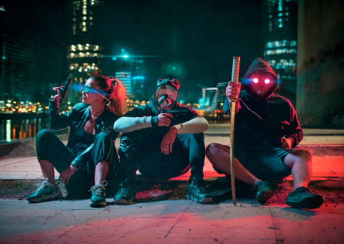 Cyberpunk gang, group of people in futuristic neon lit city