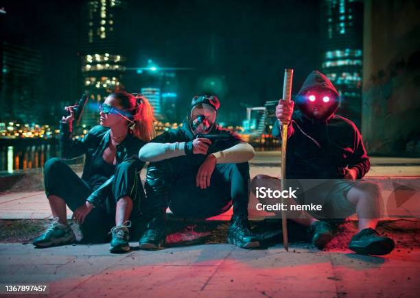 Cyberpunk Gang Group Of People In Futuristic Neon Lit City Stock Photo - Download Image Now