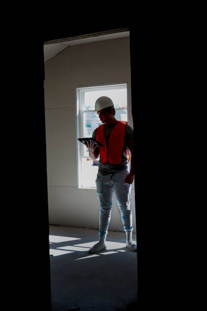 istock LV New Home Construction - Blue collar construction.  Youngman wearing hardhat and safety vest. 1367898700