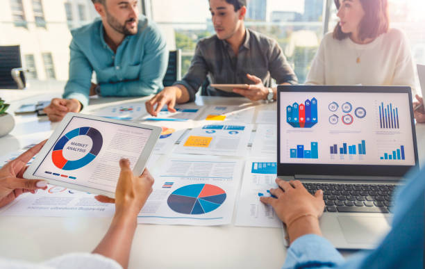 istock Group of people meeting with technology and paperwork. 1367899891
